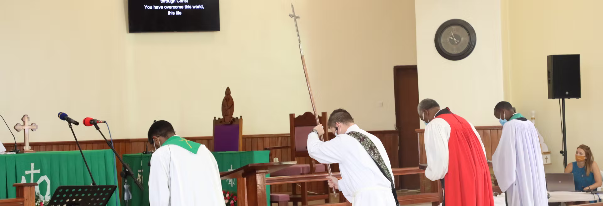 Priests bowing before the altar during worship at Holy Trinity Cathedral